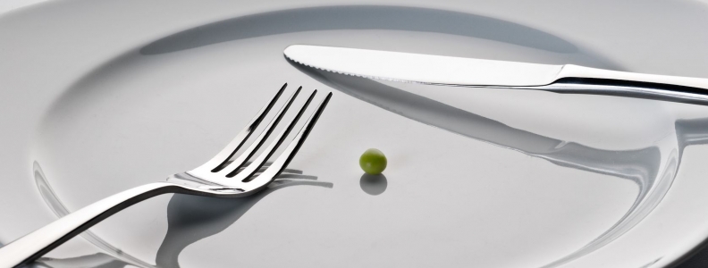 A single pea on a plate with knife and fork. Fasting studies show it may help people live longer.