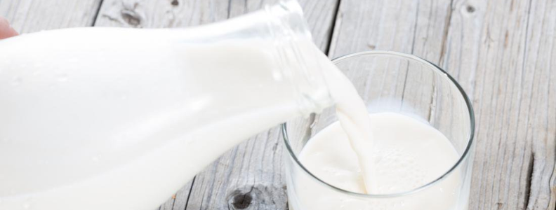 pouring a glass of milk, which can help you reach the daily recommended goal for calcium and vitamin D