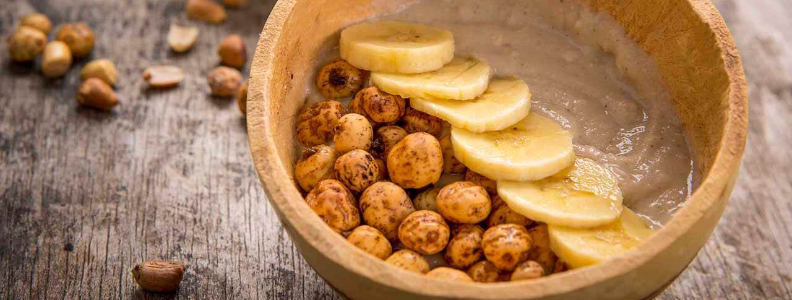 Tiger nuts in a bowl with bananas and warm cereal. One serving of tiger nuts contain more potassium than a banana.