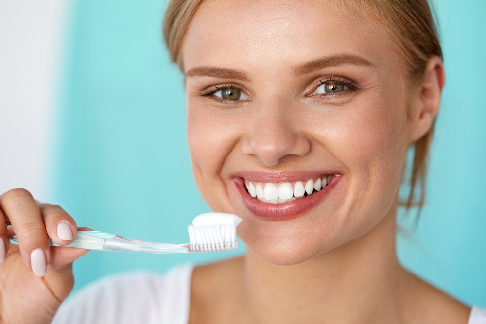 woman brushing her teeth.