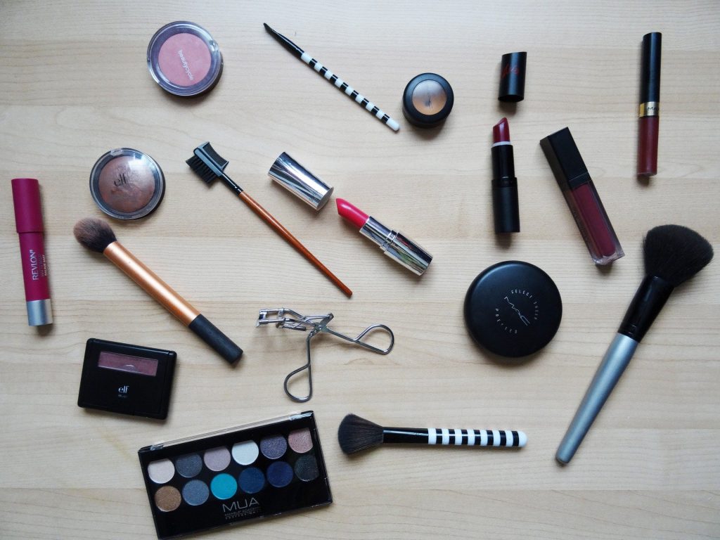 makeup and brushes laid out on a table
