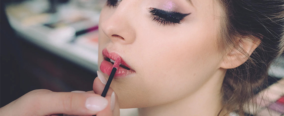 Woman having lipstick applied