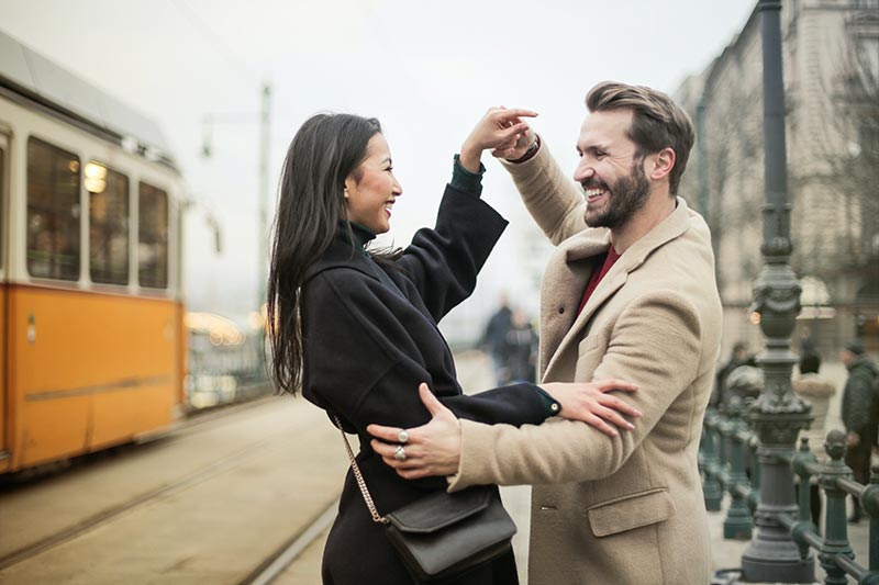 Man and woman dancing in the street.